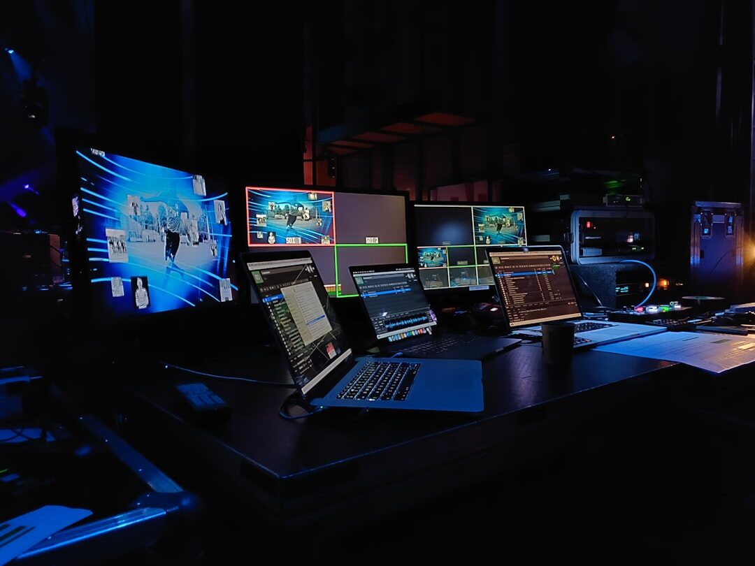 Digital media technology with multiple screens showing audio waveforms and editing software